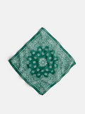 The Bandana in Cotton Voile is a vintage Italian-made accessory, crafted from soft cotton voile in green with a classic white paisley pattern, shown laid flat on a white background.