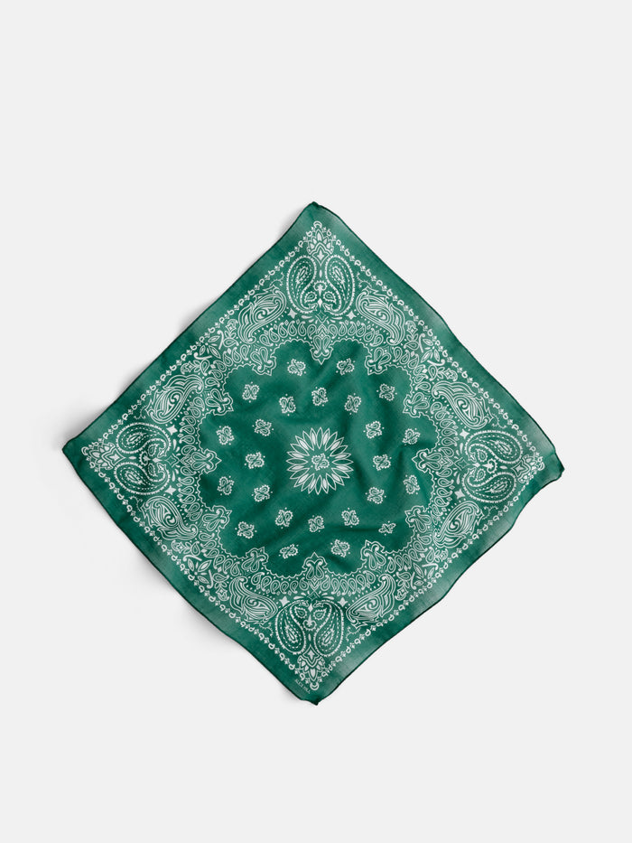 The Bandana in Cotton Voile is a vintage Italian-made accessory, crafted from soft cotton voile in green with a classic white paisley pattern, shown laid flat on a white background.