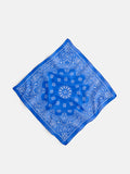 The Bandana in Cotton Voile, featuring a blue hue with a white paisley pattern and made from soft cotton voile, lies flat on a white background, positioned diagonally like a diamond.