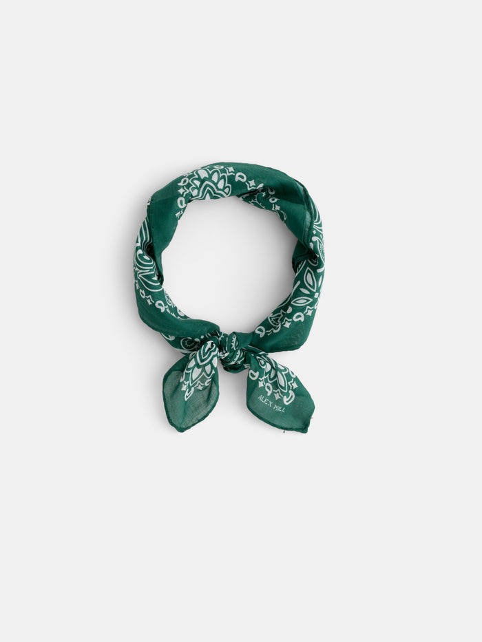 The Bandana in Cotton Voile features a vintage green paisley pattern and is tied in a loose knot against a plain white background. Expertly crafted in Italy from lightweight cotton voile, it exudes timeless style.