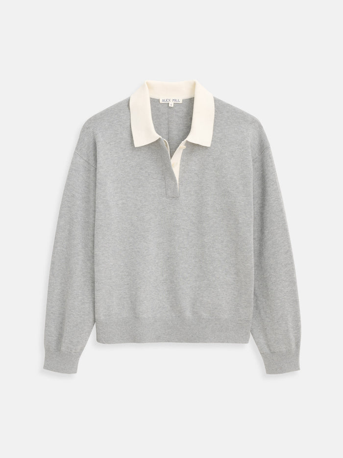 The Bond St Polo in Cotton Cashmere is a light gray women’s rugby shirt featuring a cream collar, partial button placket, and relaxed fit, shown on a plain white background.