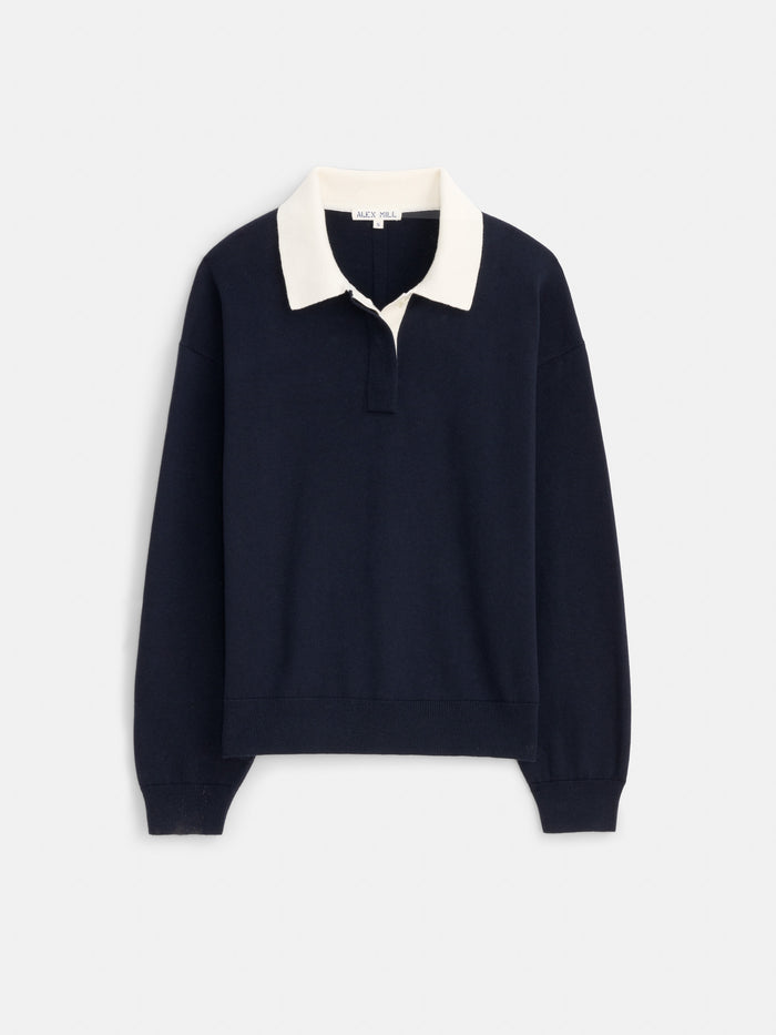 The Bond St Polo in cotton cashmere features a relaxed fit, navy blue color, white wide collar, and long sleeves. This rugby-style sweater is showcased on a plain white background.