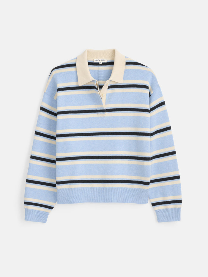 The Bond St. Striped Polo in Cotton Cashmere features a light blue long-sleeve knit design with cream, navy, and white horizontal stripes, a cream collar, and a partial button placket. Its relaxed fit echoes the comfort of your favorite oversized sweater and is showcased here laid flat on a white background.