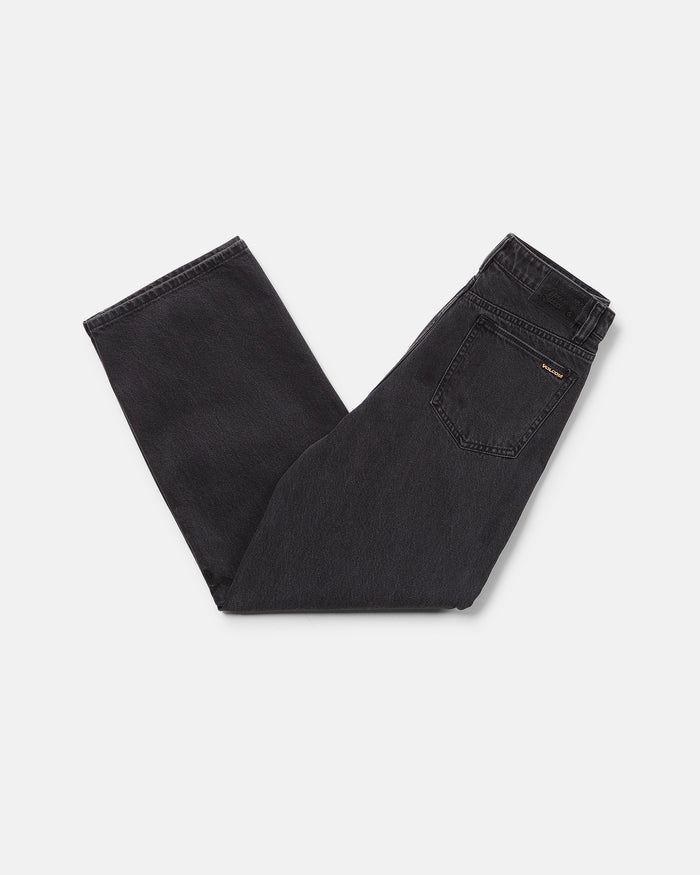 A pair of Volcom Boy's Big Boys' Billow Denim II Pants in black, folded neatly on a white background with the back pocket and waistband visible.