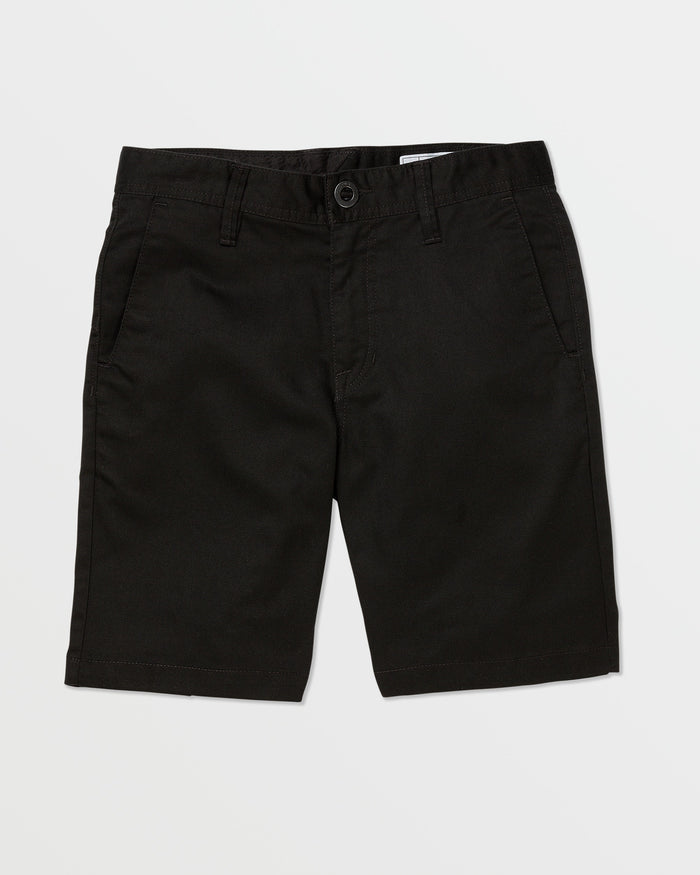 A pair of black Volcom Kids' Frickin Chino Shorts 16" with a modern fit, front pockets, belt loops, and a button closure is laid flat on a white background.