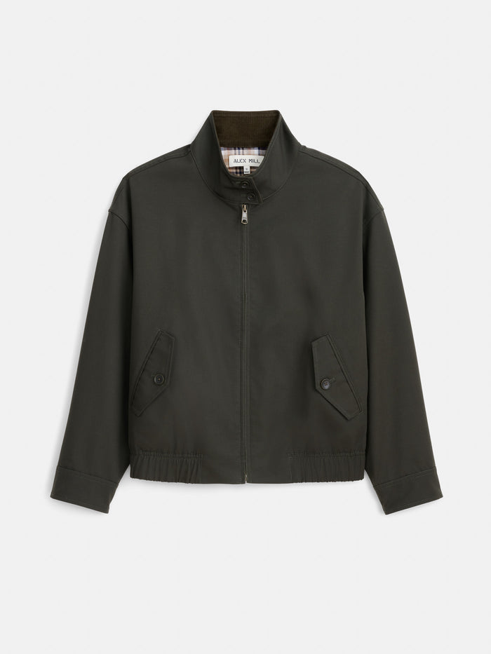 The Brighton Zip Jacket in Twill Gabardine, shown in dark green on a white background, is crafted from Italian gabardine water-repellent fabric by Olmetex and features a stand collar, long sleeves, two front button-flap pockets, and an elastic waistband.