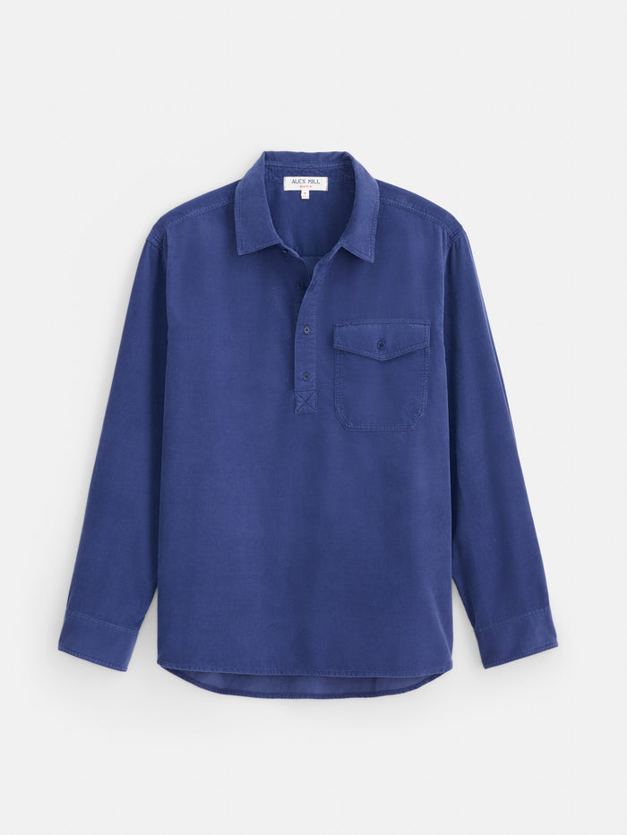Introducing the Carter Popover in Fine Wale Corduroy—a men’s casual shirt in blue, featuring long sleeves, a button-up design, lightweight corduroy fabric, and a single chest pocket, shown against a plain white background.