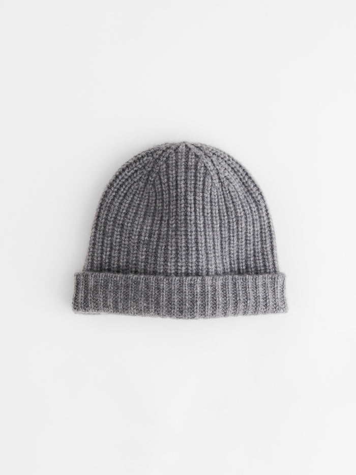 The Cashmere Beanie, shown in gray and featuring a folded brim, is crafted from supersoft cashmere and displayed flat on a white background.