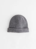 The Cashmere Beanie, shown in gray and featuring a folded brim, is crafted from supersoft cashmere and displayed flat on a white background.