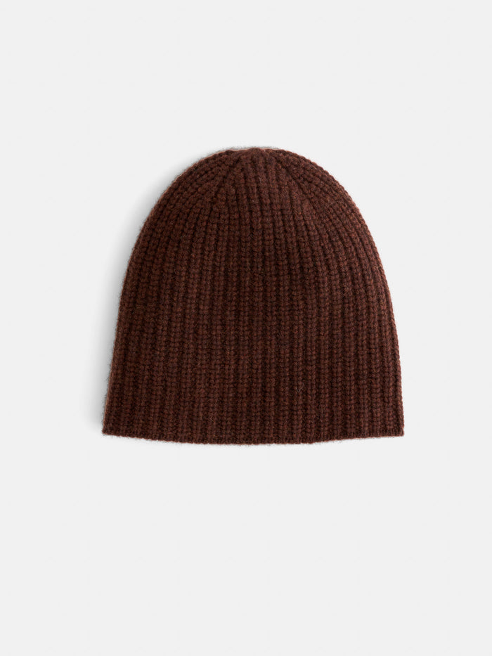 The Cashmere Beanie in brown features a ribbed knit design and is displayed on a plain white background, providing a soft and warm feel for cold days.