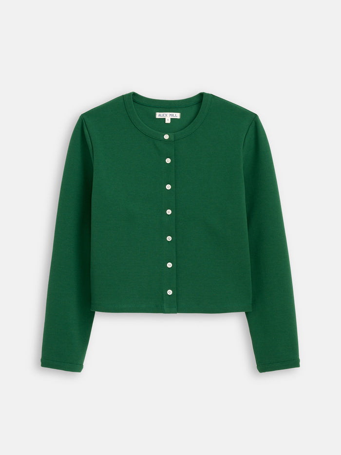 The Coco Sport Cardigan is a long-sleeved, green button-up made from emerald stretch cotton jersey with Troca shell buttons, shown laid flat on a white background.