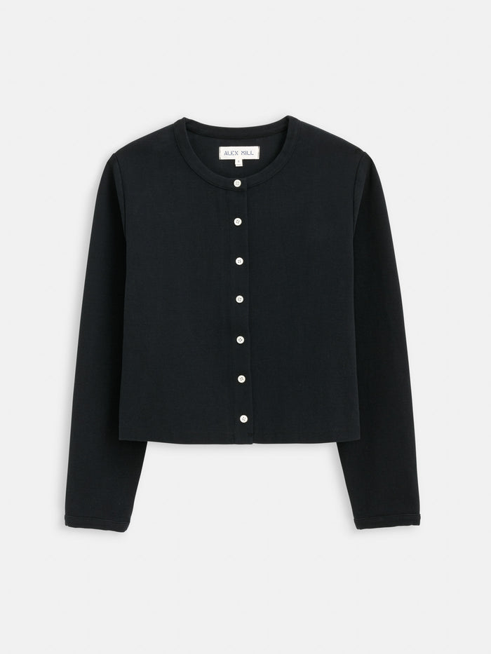 The Coco Sport Cardigan is a black, long-sleeve, cropped designer top made from stretch cotton jersey, featuring a round neckline and elegant troca shell buttons—shown against a white background.