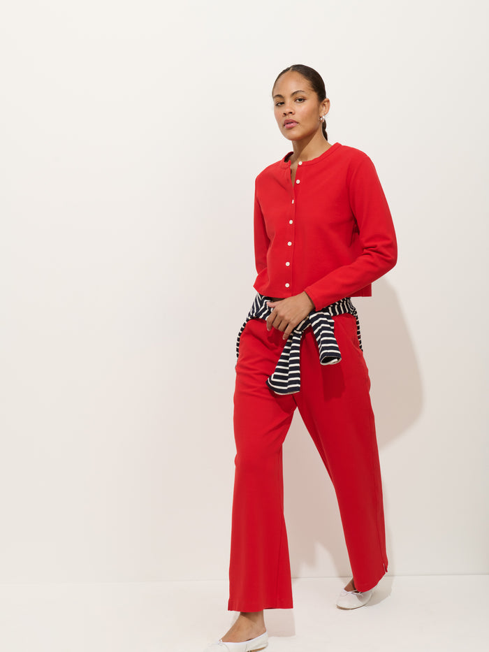 Woman wearing Coco cardigan in red with Coco Pant