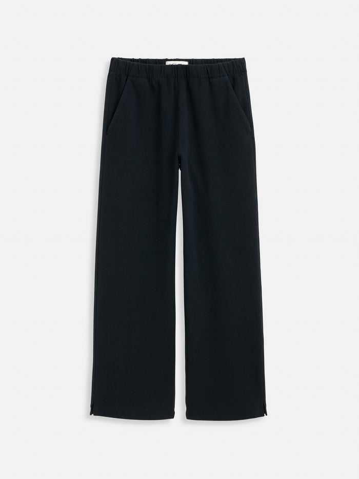 A pair of black Coco Sport Pants, made from stretch cotton jersey with an elastic waistband and side pockets, laid flat on a white background—an elevated staple for any women’s designer wardrobe.