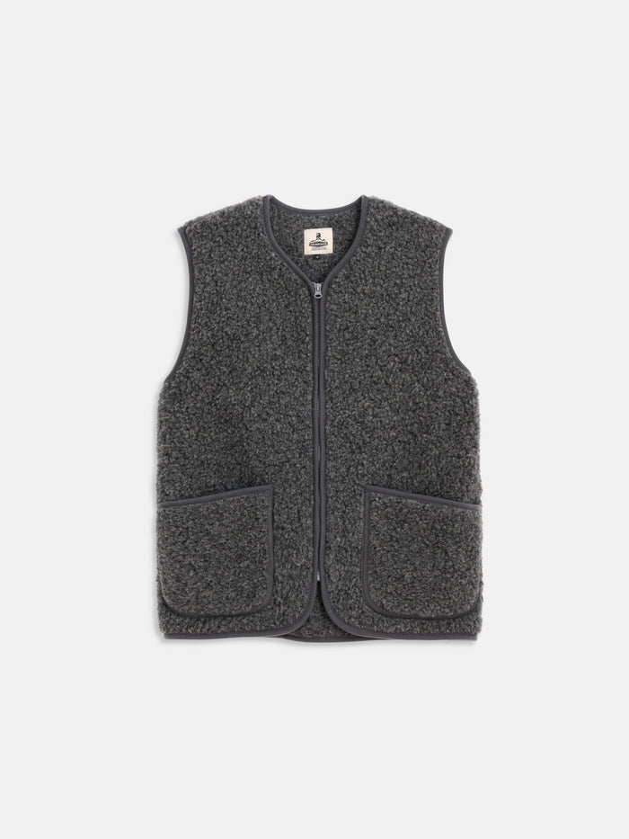 The Coldbreaker Standard Vest is a dark gray, sleeveless fleece vest made from Irish wool, unisex sized, with a front zipper, rounded neckline, and two large front pockets, shown against a plain white background.