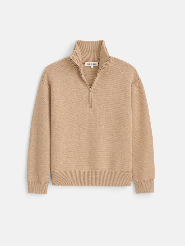 Daphne Half-Zip Sweater in Cotton Cashmere shown in beige, featuring long sleeves, a ribbed texture, high collar, ribbed cuffs and hem, and an oversized fit, laid flat on a white background.