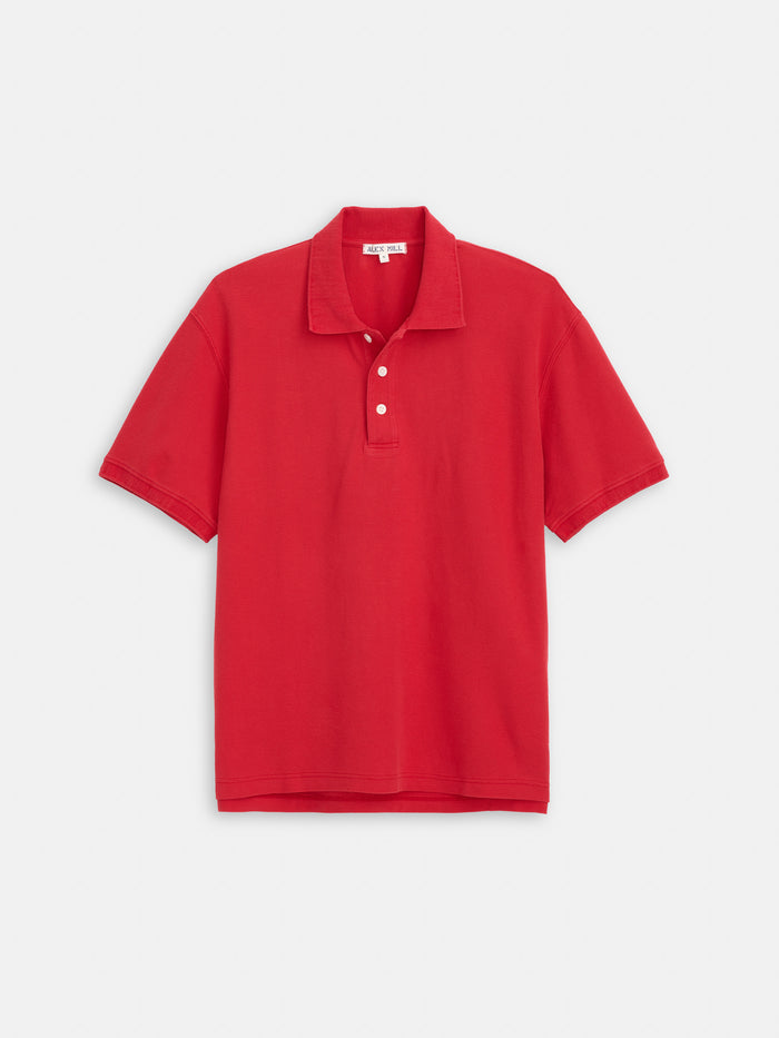 The Garment Dyed Polo In Pique Cotton is a plain red 100% cotton polo shirt featuring a collar and three white buttons, shown laid flat on a white background.
