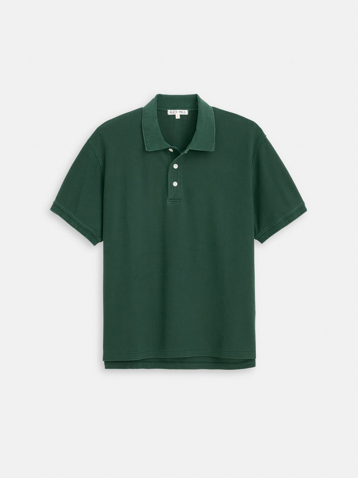 The Garment Dyed Polo In Pique Cotton is a dark green shirt with short sleeves, a collar, and three white buttons, shown flat on a white background.