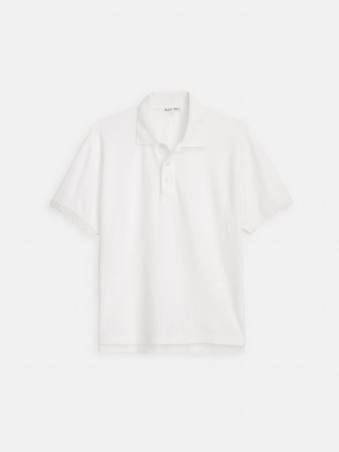 The Garment Dyed Polo In Pique Cotton, featuring a collar and two-button placket, is crafted from 100% cotton and shown against a white background.