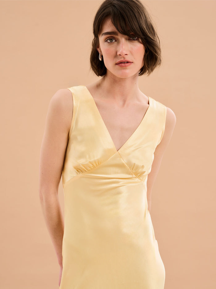 yellow satin maxi dress with v neck and ruching detail