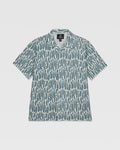 The Volcom Kids' Boldstone Short Sleeve Tee features a boxy fit, collar, and button-up front with an allover abstract blue and white brushstroke print. It's shown laid flat on a white background.