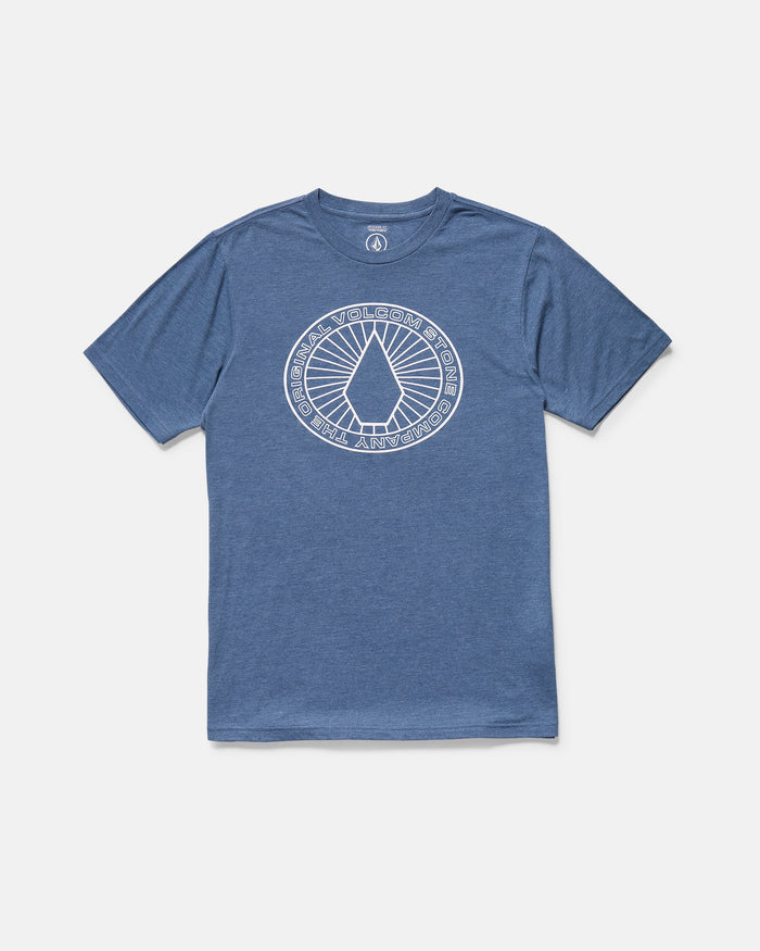 The Volcom Men's Men Medalist tee is a blue short sleeve crew neck with a large circular white graphic, geometric shapes, and "Volcom Stone" plus "Go Against the Flow" text on the chest. Modern fit for comfort and style.