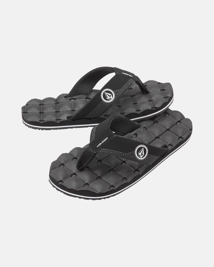 A pair of Volcom Kids' Recliner 2 Big Youth black sandals with a textured, woven-like comfort foam footbed and logo on the straps, shown on a plain white background.