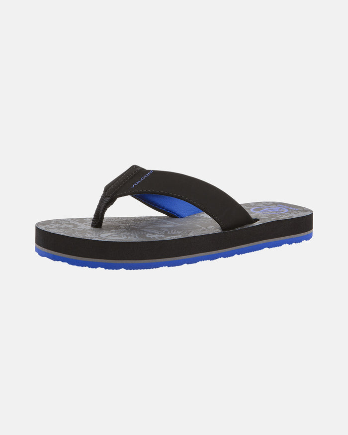 The Volcom Kids' Victor 2 Big Youth sandal features a black strap with blue accents, a gray patterned footbed, a thick sole with blue bottom, non-scuff outsoles, and water-friendly comfort—all shown against a plain white background.