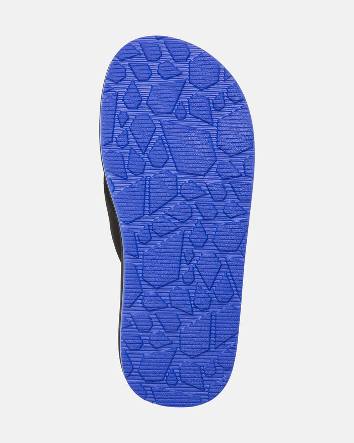 The image shows the bottom of the Volcom Kids' Victor 2 Big Youth sandal with a bright blue, geometric-textured sole for grip. Non-scuff outsoles keep floors mark-free. The background is white.