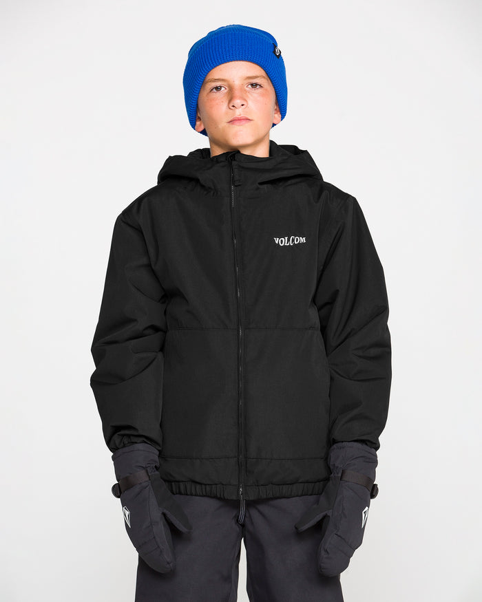 A boy wearing a blue beanie, black gloves, and the Volcom Kids’ Youth Chaos Insulated Jacket stands against a plain white background, looking straight ahead with a neutral expression.