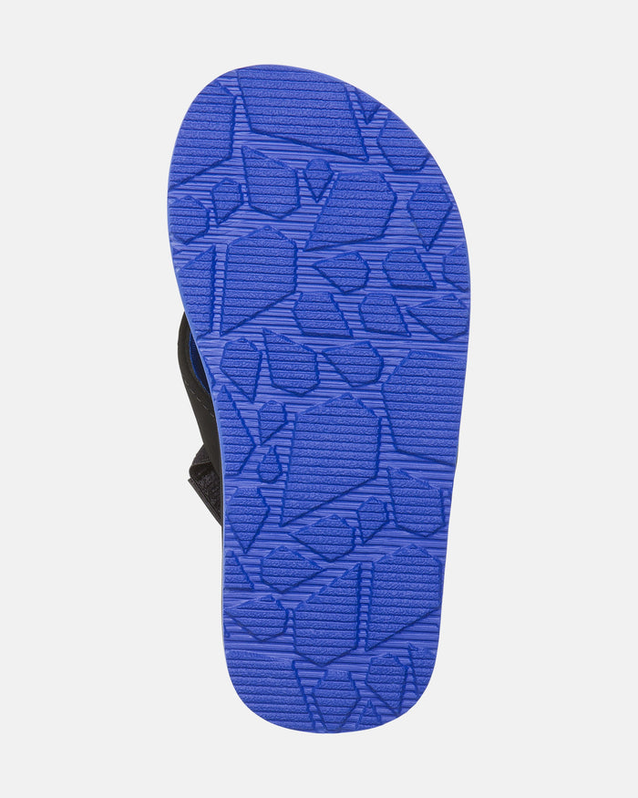 The image shows the bottom sole of the Volcom Kids' Victor 2 Little Youth sandal. It features a bright blue, geometric textured sole for grip, ideal for water activities, with partially visible straps on the sides.