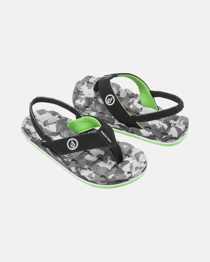 The Volcom Kids' Recliner 2 Little Youth sandals feature black straps with green accents, a gray/white/black camo sole, comfort foam footbed for all-day support, and the Volcom logo on the straps.