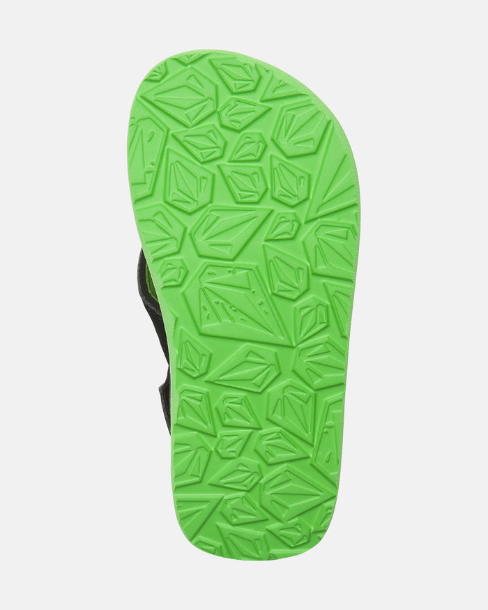 The image shows the sole of the Volcom Kids' Recliner 2 Little Youth sandal, featuring a bright green color and a geometric textured tread pattern on a white background.