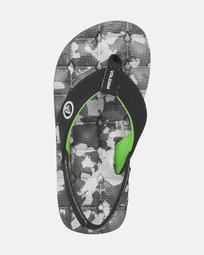 The Volcom Kids' Recliner 2 Little Youth sandal features black straps with the Volcom logo on white, a black and gray camo-patterned sole, green accents, and a comfort foam footbed.