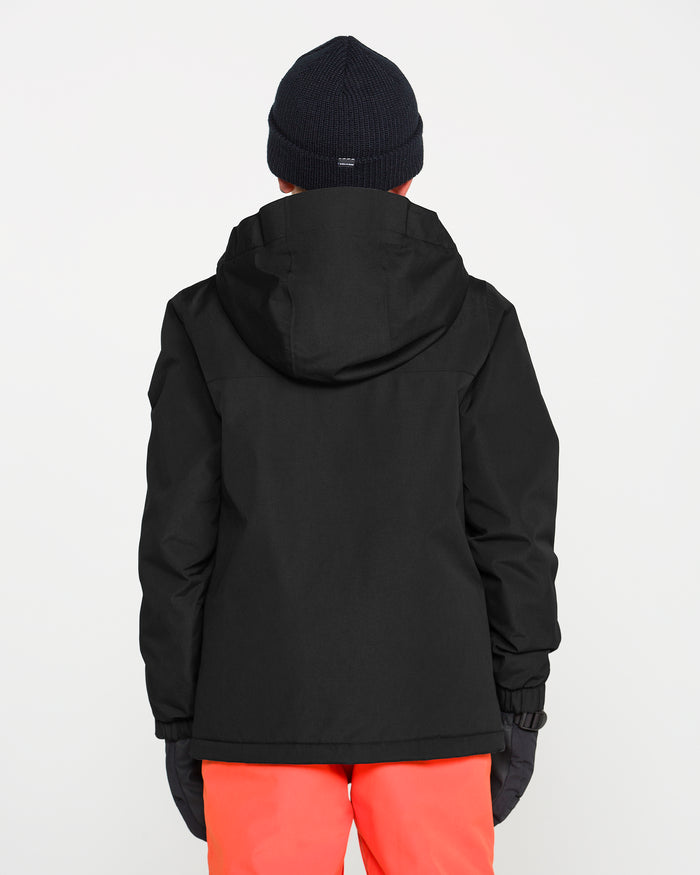 A person is standing with their back to the camera against a plain white background, wearing the Volcom Kids’ Youth Stone.91 Insulated Jacket in black, which features recycled insulation, along with a black knit hat and red pants.