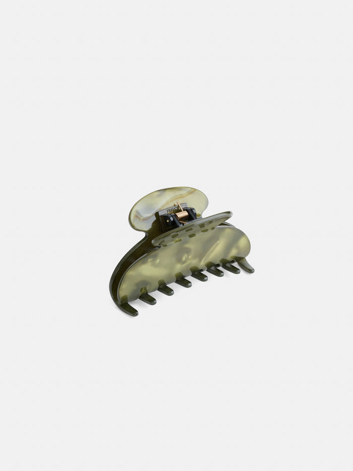 The Large Round Claw is a green marbled hair claw clip, handcrafted in France from premium acetate, featuring a curved design and interlocking teeth, displayed against a plain white background.