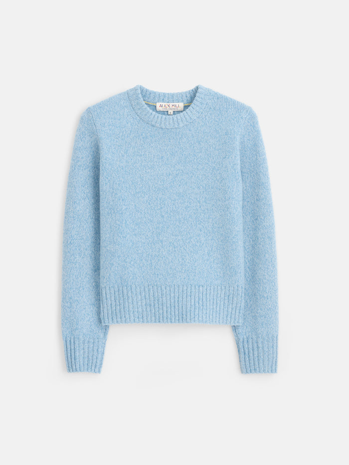 The Marais Sweater in Cashmere is a light blue, long-sleeve, crew neck sweater crafted from 100% cashmere for exceptional softness and luxury, featuring ribbed cuffs, hem, and neckline. It is shown laid flat on a white background.