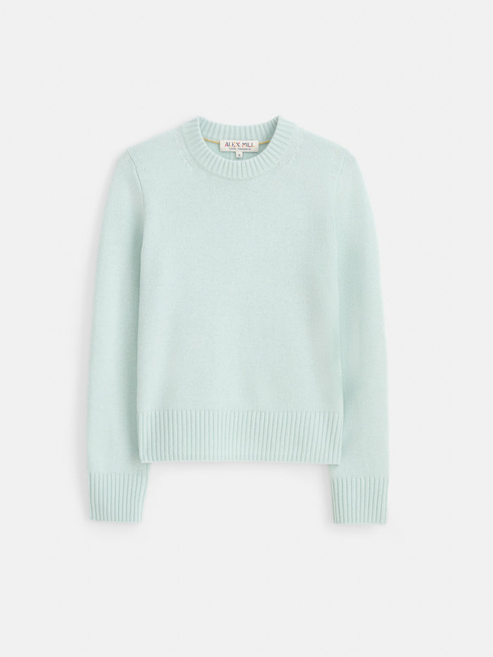 The Marais Sweater in Washed Cashmere is a light blue, long-sleeve luxury knit crafted from 100% cashmere, featuring ribbed cuffs, hem, and a crew neckline for extra softness, displayed on a white background.