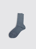 A pair of Maria La Rosa Bio Cotton Ribbed Socks in blue-gray is neatly laid out on a light gray background.