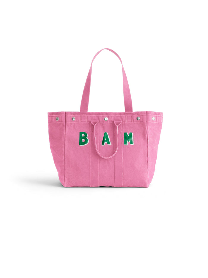 Introducing the Memorial Sloan Kettering Cancer Center × Alex Mill Perfect Weekday Tote—a personalized pink bag featuring two sturdy handles and bold green “BAM” lettering on the front. Set against a plain white background, this standout tote is perfect for supporting breast cancer research or expressing your unique style.