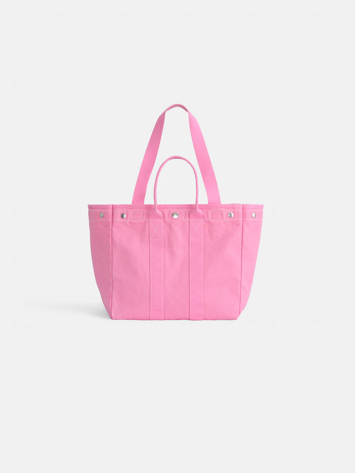 The Memorial Sloan Kettering Cancer Center × Alex Mill Perfect Weekday Tote is a large pink tote with two handles and silver rivet details, ideal for customizing or showing stylish support for breast cancer research.