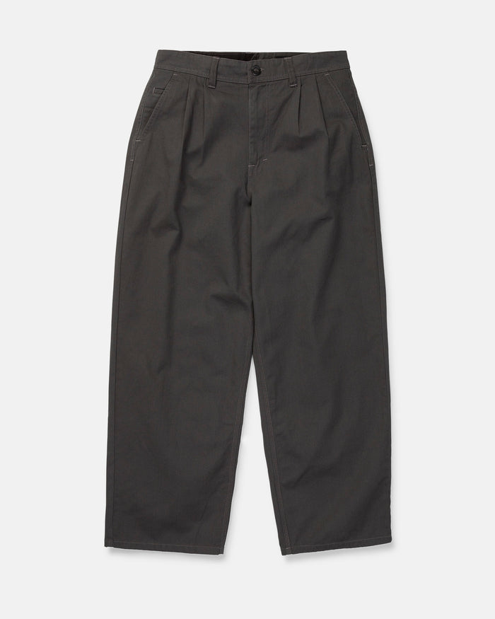 The Volcom Men's Baggos Pleat Pants are wide-leg, high-waisted charcoal gray pants made from cotton chino fabric, featuring pleats, side pockets, and a button and zipper closure, shown flat on a white background.