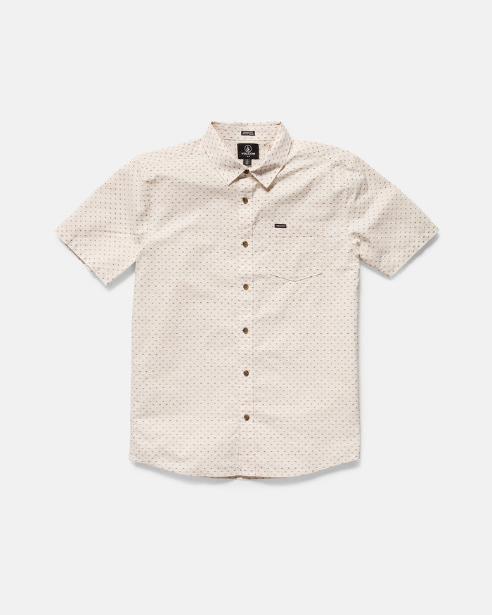 The Volcom Men's Bankstone II Short Sleeve Tee features a classic fit, beige color, subtle textured dobby dotted pattern, front chest pocket, and brown buttons, displayed laid flat on a white background.