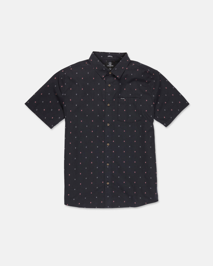 The Volcom Men's Bankstone Short Sleeve Shirt is a classic-fit, short-sleeved button-up featuring a black base with a small pink polka dot pattern and a front chest pocket, showcased on a plain white background.