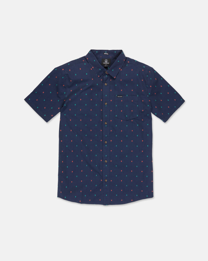 The Men's Bankstone Short Sleeve Shirt by Volcom is a navy blue, classic fit button-up featuring a collar, front pocket, and an all-over pattern of small red and light blue dots. Crafted with subtle dobby weave detailing, the shirt is shown laid flat on a white background.