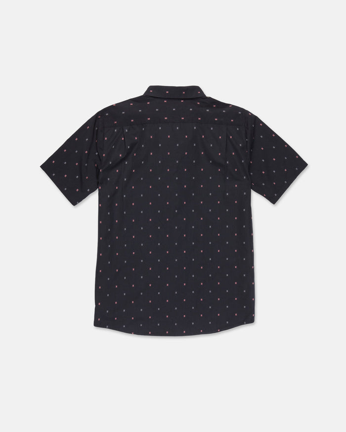 The Volcom Men's Bankstone Short Sleeve Shirt is featured in black with a subtle red and white dotted pattern, displayed from the back against a plain white background. This classic fit button-up is crafted from a comfortable cotton-poly blend, making it ideal for versatile, everyday wear.