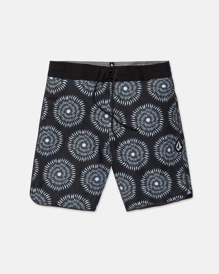 Men's Barnacle Stoney board shorts by Volcom, featuring a black base with a white and gray circular geometric pattern, a black drawstring waistband, and a small white Volcom logo on the left leg. Made from a comfortable hemp-cotton blend, these shorts are displayed flat on a white background.