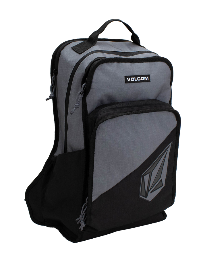 The Men's Boundary Backpack by Volcom is a gray and black bag featuring two front zippered compartments, a top handle, and the Volcom logo on the lower pocket.