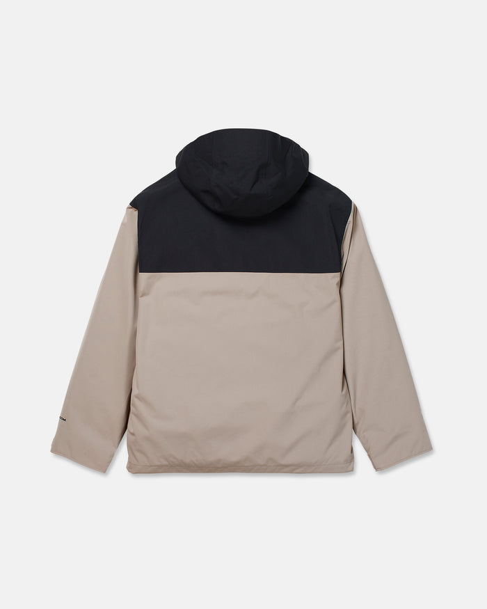 The Men’s Buckthreeeighty Insulated Jacket by Volcom is a two-tone design featuring a beige body and sleeves, contrasted with a black upper back and hood. Crafted from recycled fabric, the jacket is displayed from the back against a plain white background.