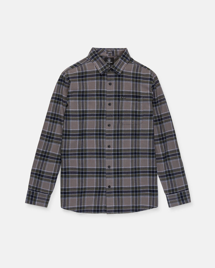 The Men's Caden Plaid Long Sleeve Shirt by Volcom is a classic-fit, button-up shirt crafted from soft cotton flannel in a blue, black, and white plaid pattern. It features a front chest pocket and classic collar, shown here laid flat on a white background.